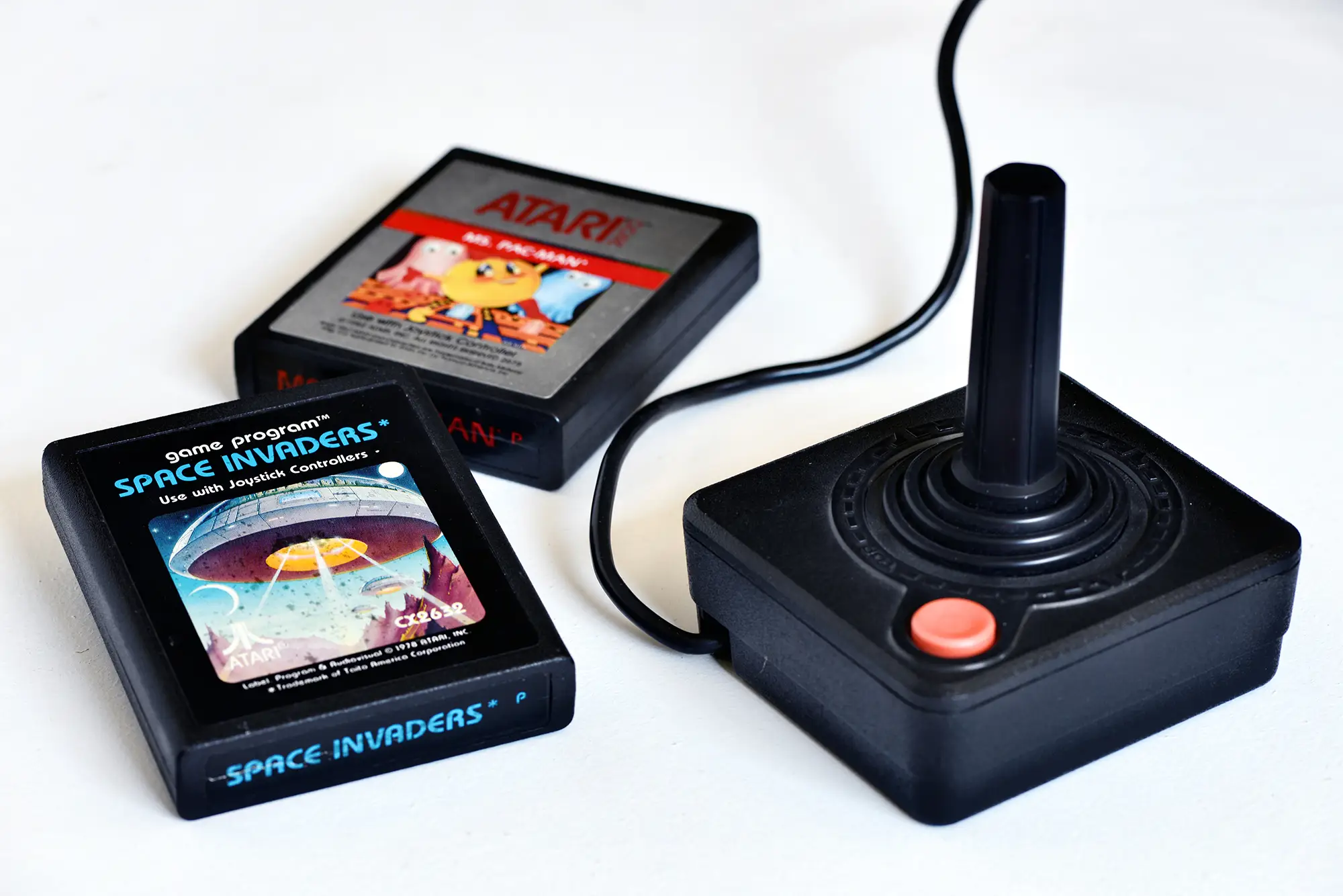 Atari joystick and two game cartridges