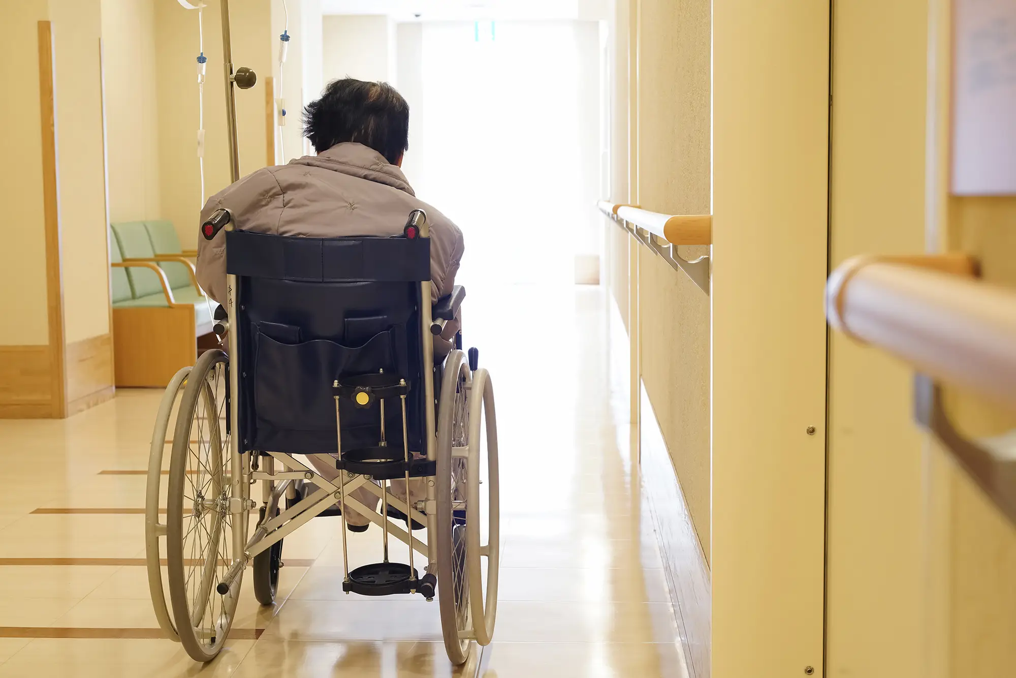 Woman in a wheelchair in the hallway of a nursing home