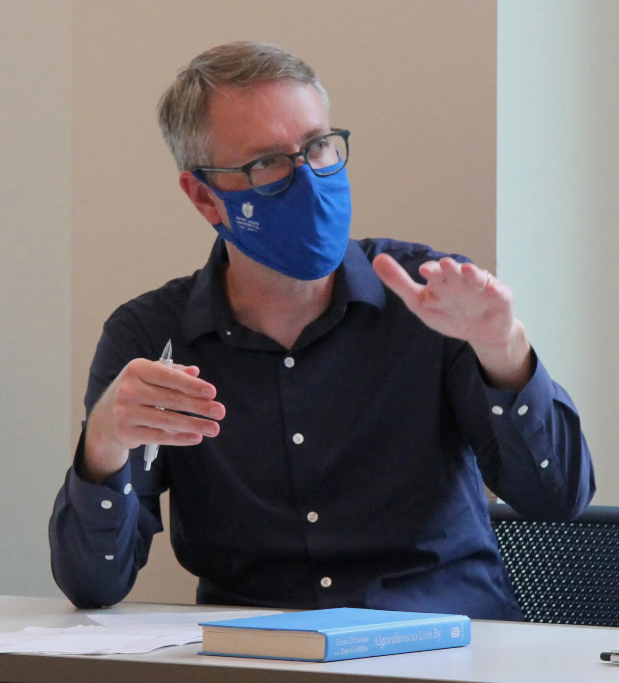 Justin Goodson teaching in a classroom while wearing a face mask